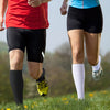 Two people running outdoors wearing medical grade compression socks for veins and sports