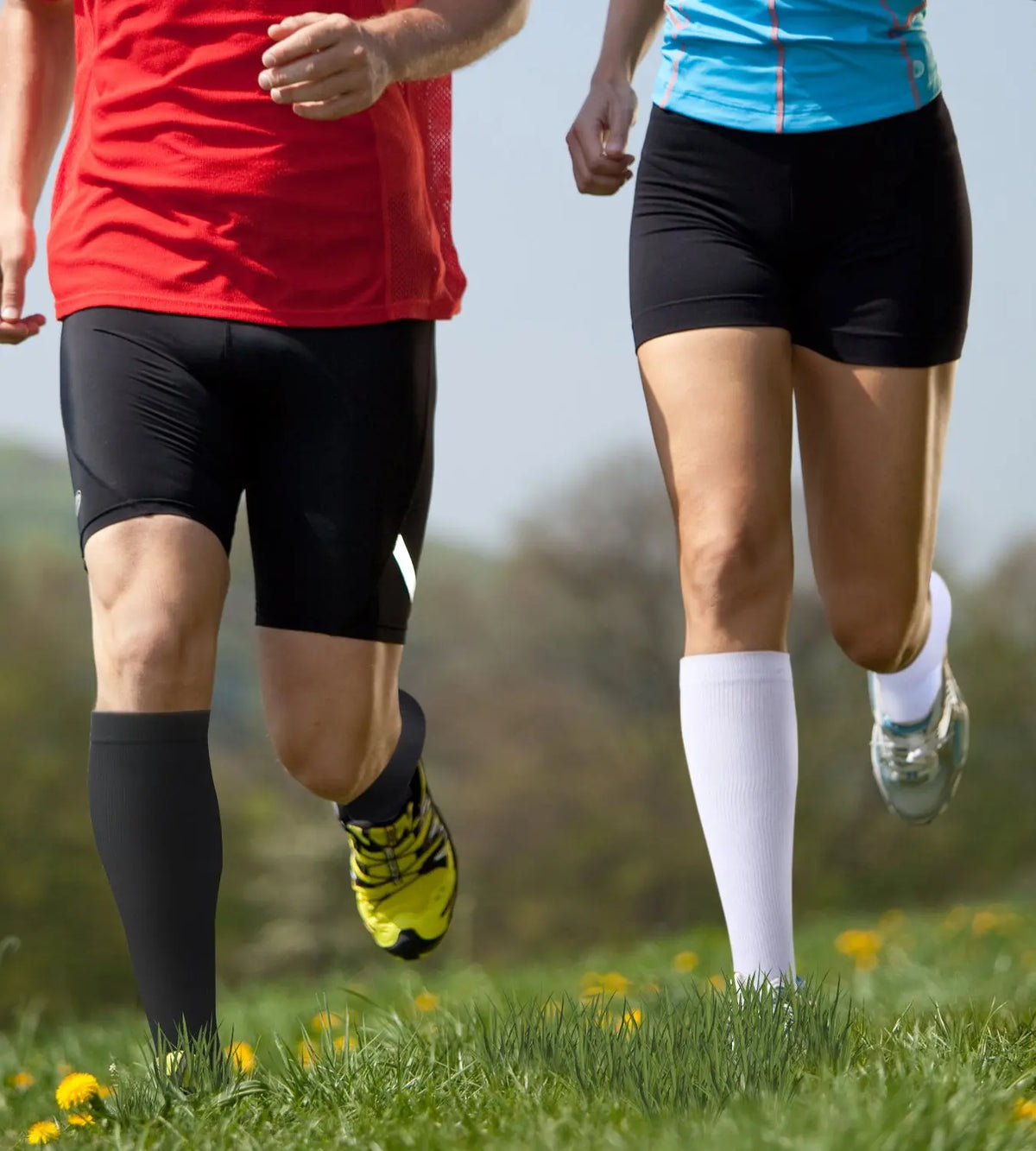 Two people running outdoors wearing medical grade compression socks for veins and sports