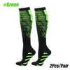 Pair of black compression socks with neon green accents for sports or athletic use