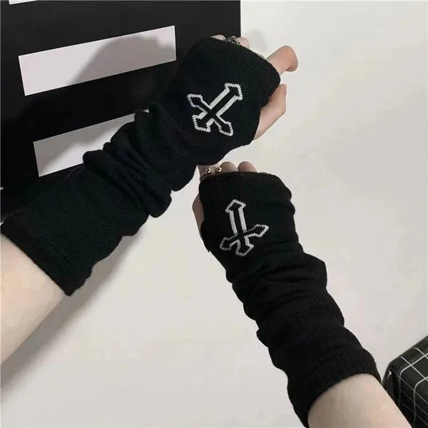 Black gothic fingerless arm warmers with a silver cross design shown on a hand.