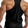A muscular man wearing a black sleeveless tank top and light gray shorts, viewed from the back.