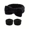 Black microfiber spa headband and wristband set with a bow detail