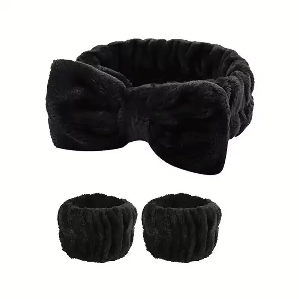 Black microfiber spa headband and wristband set with a bow detail