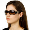 A woman models black Y2K cat eye rhinestone sunglasses with dark brown hair against a white background.