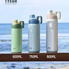Three TYESO insulated stainless steel water bottles in green, blue, and white colors displayed outdoors.