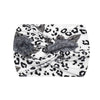 A white fabric headband with a black leopard print pattern, tied in a knot.