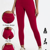 A model wears deep red high-waist yoga leggings demonstrating a V-shape design and hip lift.