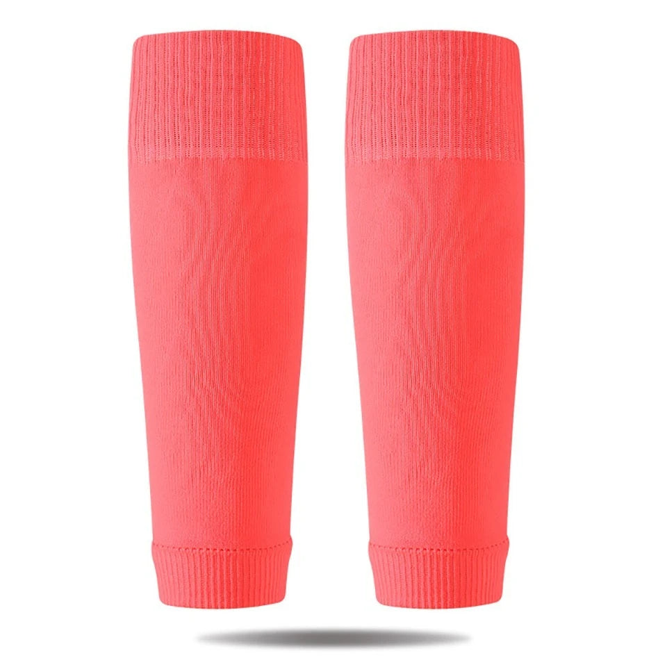 A pair of bright coral pink compression sleeves for soccer and sports.