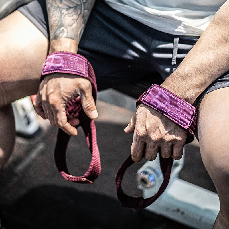 A close-up of a person's hands wearing purple gym wrist wraps while performing a strength training exercise.