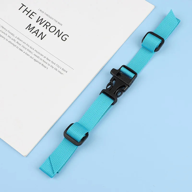 A bright blue adjustable tactical backpack strap harness is displayed next to a book titled The Wrong Man.