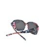 A pair of wrap-around sunglasses with a floral pattern featuring pink, purple, and blue tones.