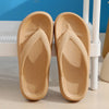 Pair of beige comfort platform flip flops resting on a white surface.