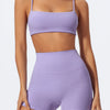 A model wearing light purple high-waist yoga and workout shorts.