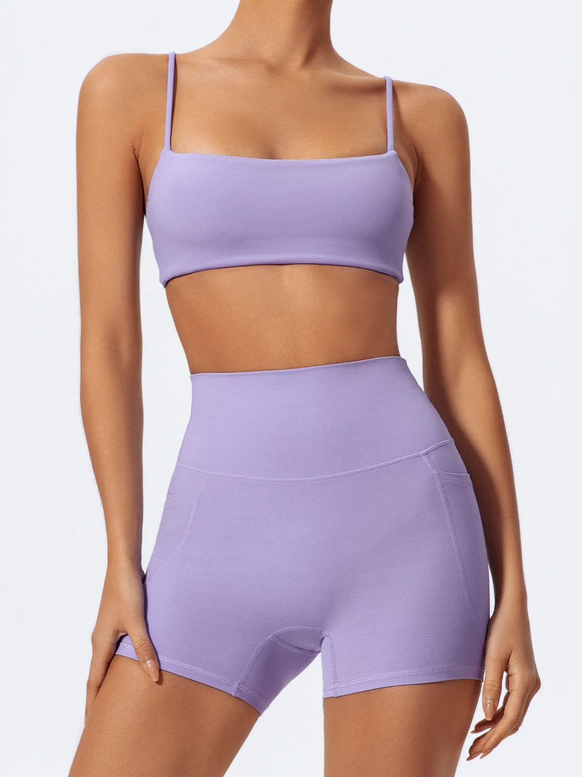 A model wearing light purple high-waist yoga and workout shorts.