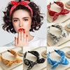 A collection of paisley bandana patterned fabric headbands and bows in red, black, and blue.
