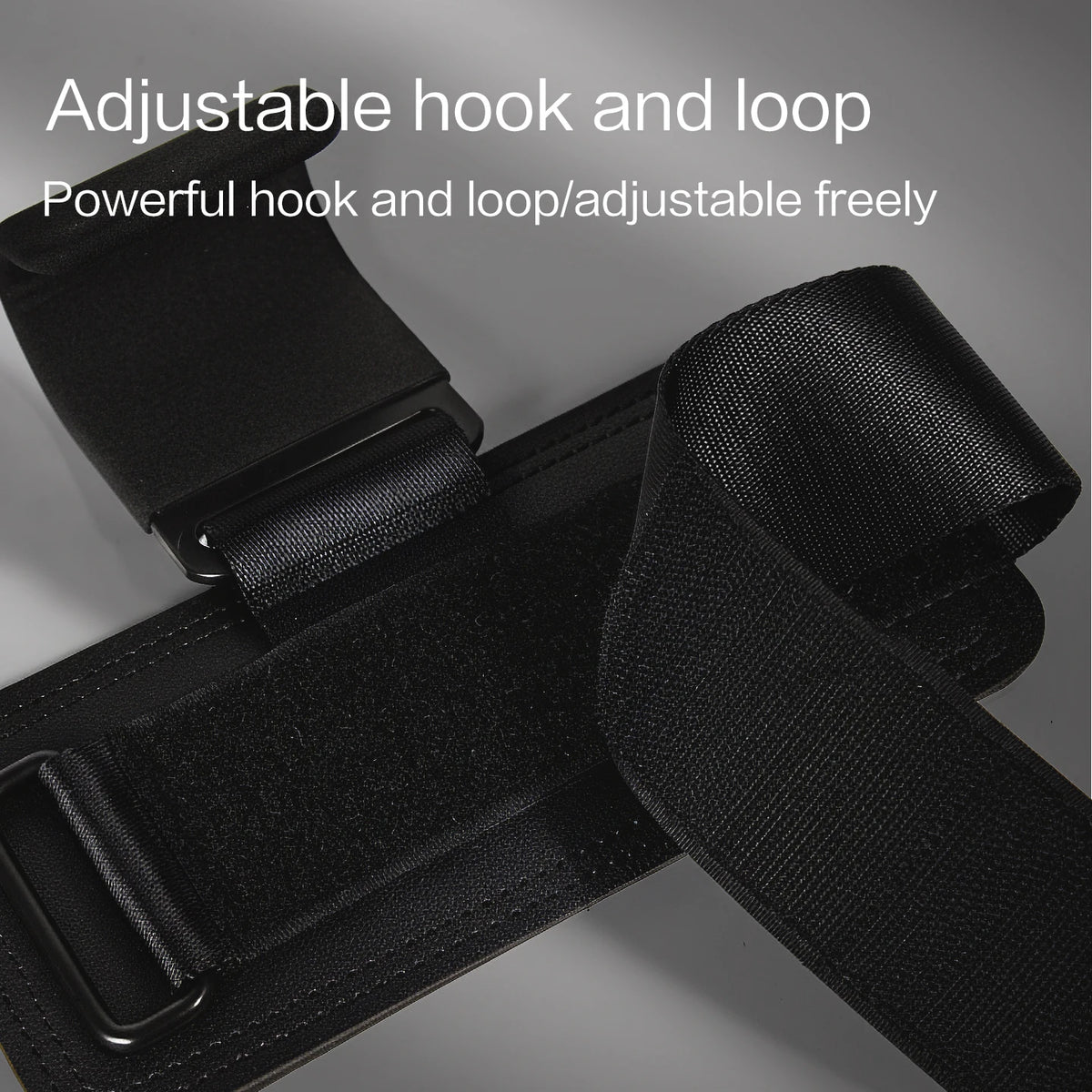 Black adjustable hook and loop strap with a padded wrist wrap shown in close-up.