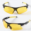 A pair of yellow-tinted sport sunglasses with black frames shown in a studio setting.