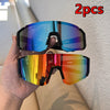 A hand holds two pairs of UV400 cycling sunglasses, one with a blue/purple tint and another with an orange/yellow tint.