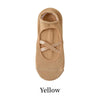 Tan yoga socks with a crisscross strap design