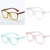 A set of four optical glasses frames in brown, clear, and pink colors shown against a white background.