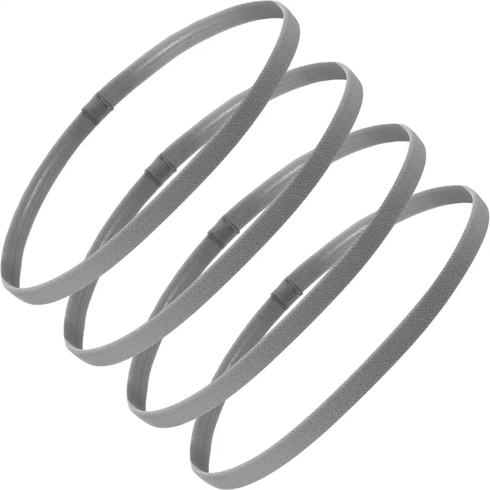 Ein Set von vier grauen elastischen Sport-Headbands, aufgerollt.