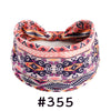 A patterned boho knotted cotton headband featuring geometric designs in pink, purple, and orange.