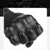A close-up view of black full finger leather motorcycle riding gloves.