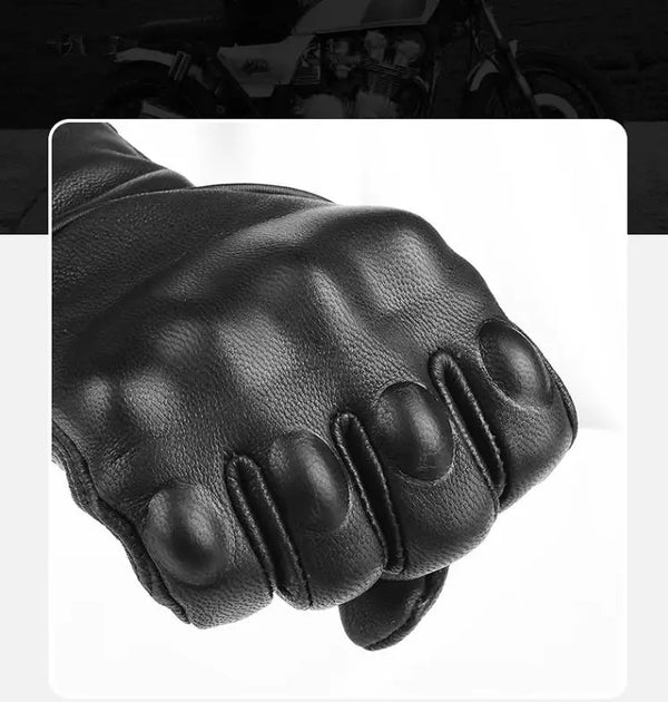 A close-up view of black full finger leather motorcycle riding gloves.