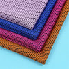 A stack of colorful microfiber cooling towels in various shades of purple, blue, pink, and orange.