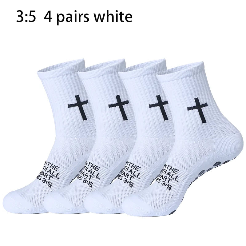Four pairs of white prayer and cross grip sports socks are displayed.