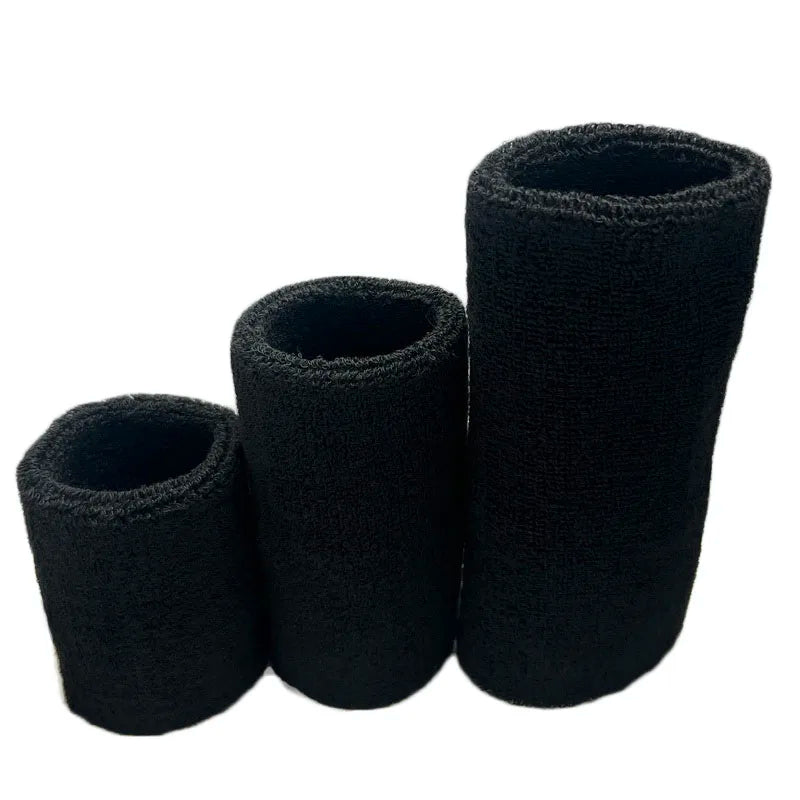 A set of three black dual sports wristbands for sweat absorption.