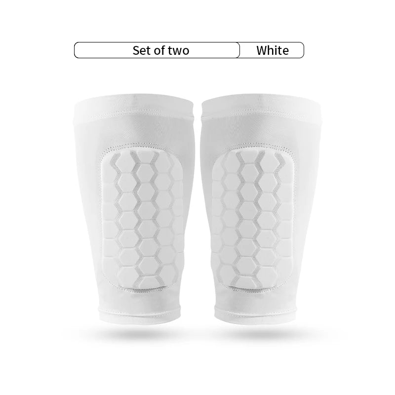 A set of two white honeycomb shin guards for football training.