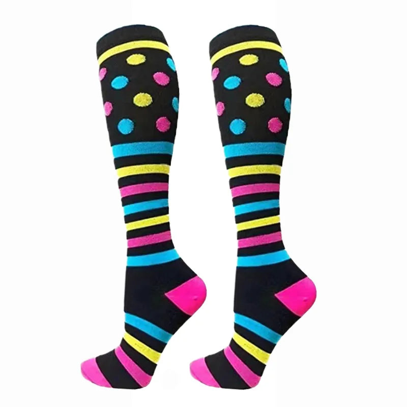 A pair of colorful compression elastic socks with black and neon stripes and polka dots.