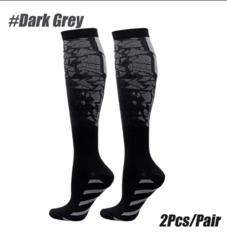 A pair of black dark grey sports compression socks shown against a white background.
