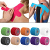 Rolls of colorful kinesiology tape used for athletic recovery and muscle support.