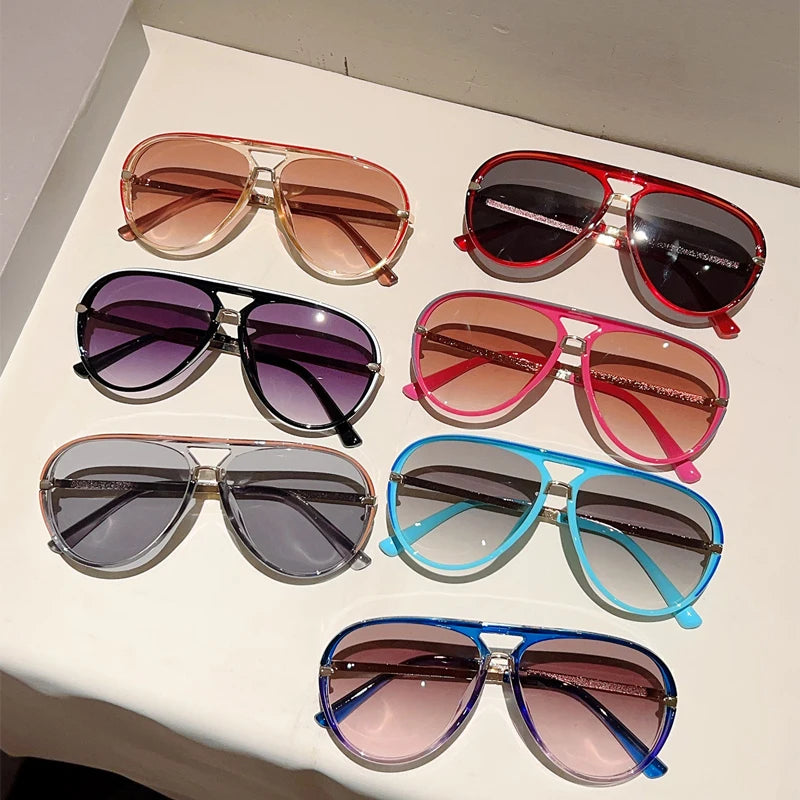 A collection of vintage pilot gradient sunglasses in various colors including rose gold, silver, purple, and blue.