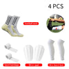 Four pairs of white football socks, sport bandages, shin pads, and shin guard socks.