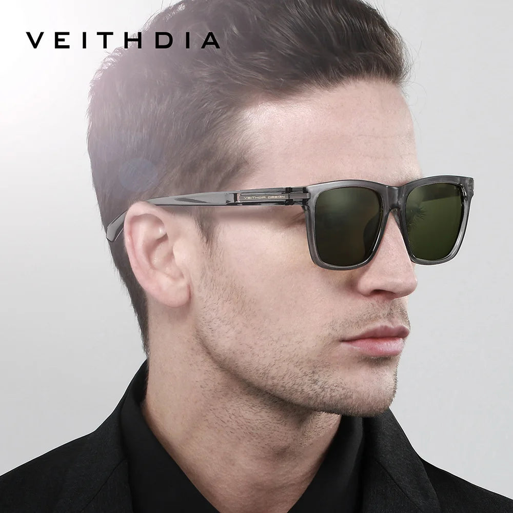 A man models classic square polarized sunglasses with dark green lenses against a light gray background.