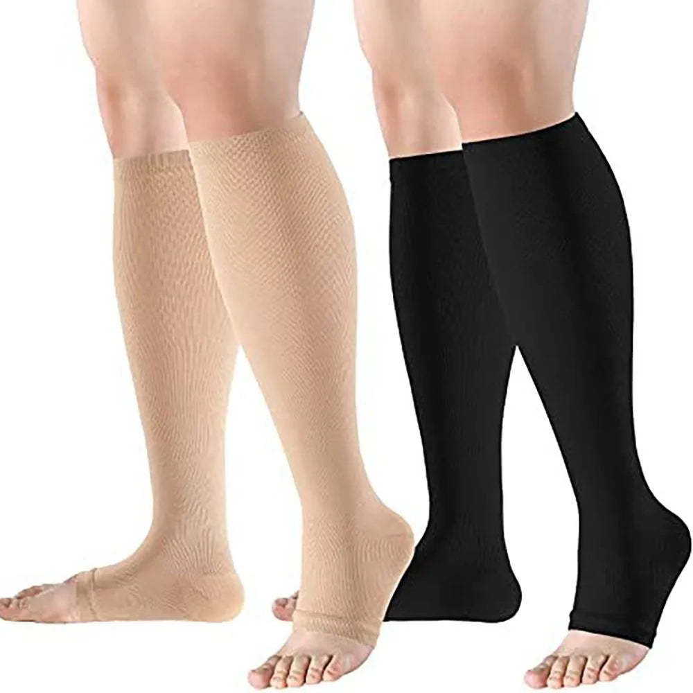 A pair of medical grade compression socks, one beige and one black, shown on a person's legs.