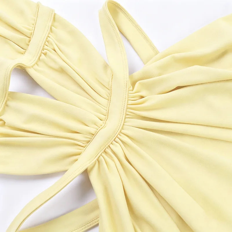A yellow elegant maxi dress featuring a draped cut-out back detail.