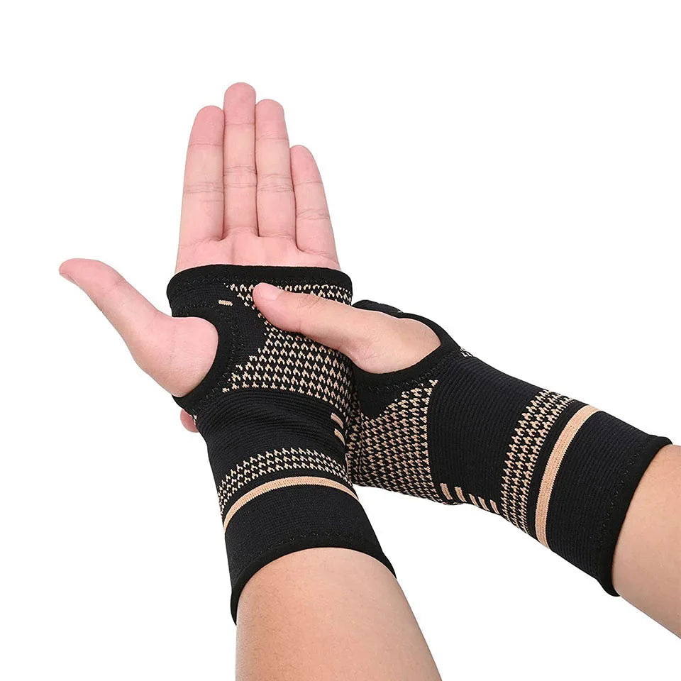 A hand wearing a black copper fiber wrist bracer for fitness and sport.