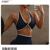 Model in dark blue sports bra and matching seamless leggings with white trim.