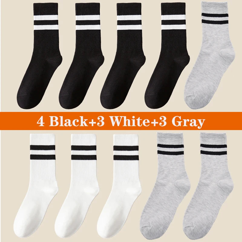 A collection of 10 sport socks in black, white, and gray colors displayed flat.