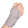 A hand wearing a gray adjustable wrist support brace for pain relief.