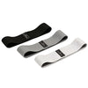 Three fabric resistance bands in black, gray, and white for glute and leg workouts