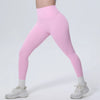 A model wearing pink high-waisted quick-drying yoga and fitness leggings with white socks and white sneakers.