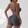 A woman models a gray tie-dye sport jumpsuit from the back view.