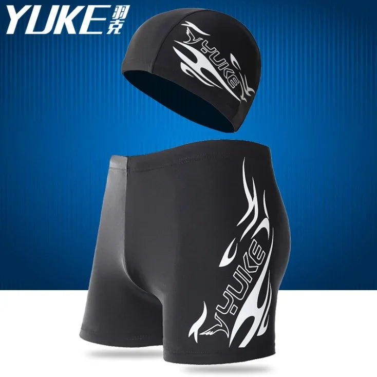 Black men's swim suit with a matching cap and earplugs displayed against a blue background.