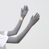 Gray UPF 50+ sun protection arm sleeves worn on an arm.