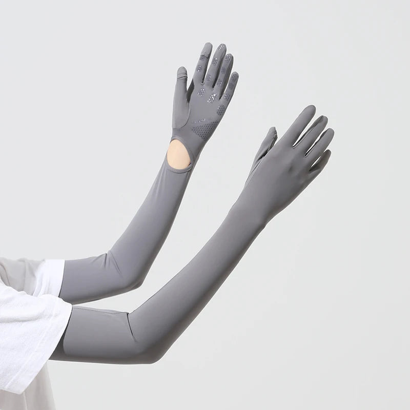 Gray UPF 50+ sun protection arm sleeves worn on an arm.